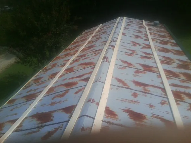 Rusted metal roof panels with new wood purlins before replacement — Storm Damage Roof Repair in Lincolnton by Roofing Brothers