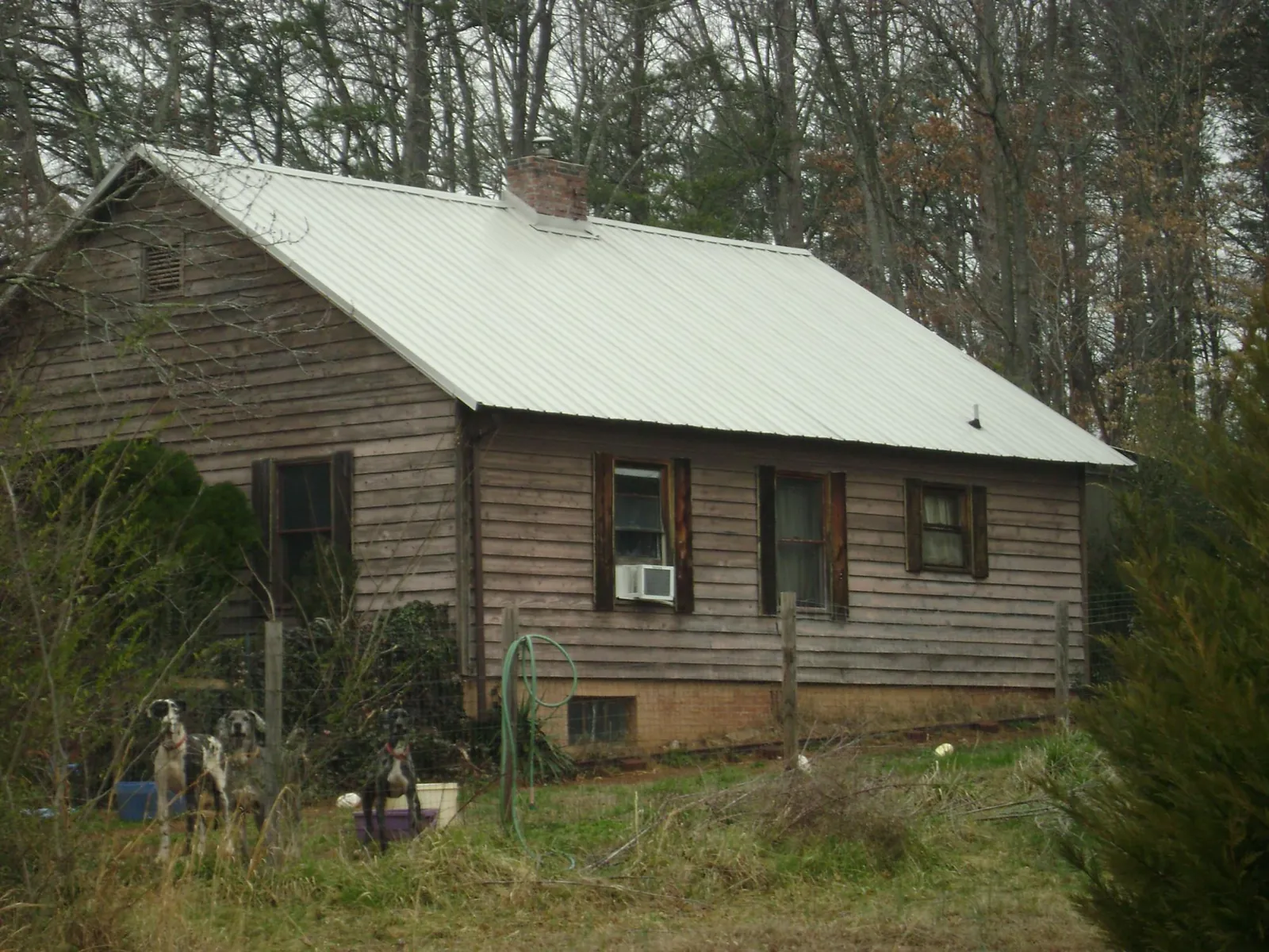White metal roof on an old wood sided farmhouse, from a Asphalt Shingle Roof Repair job in Lincolnton